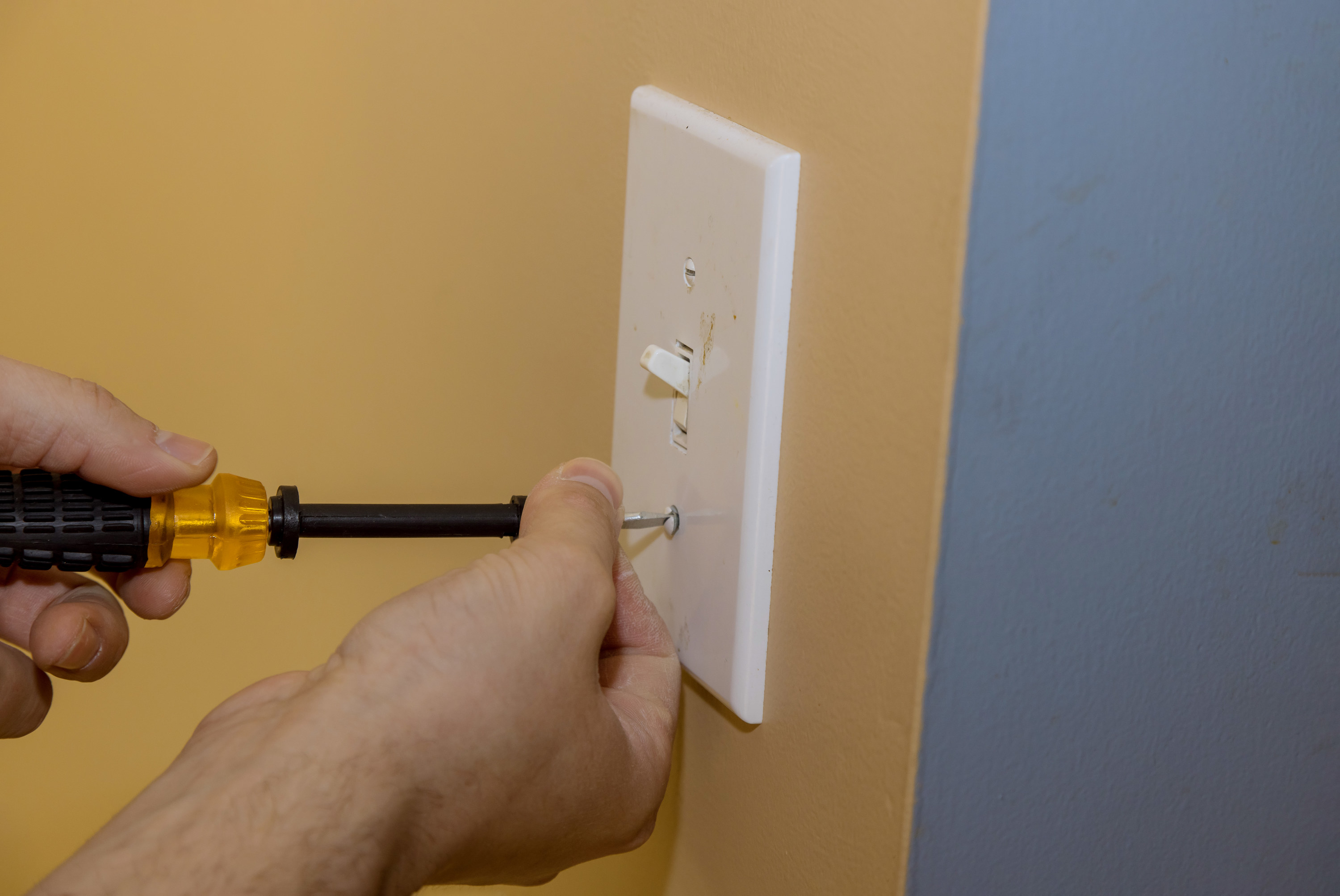 installing a new light switch cover on the wall