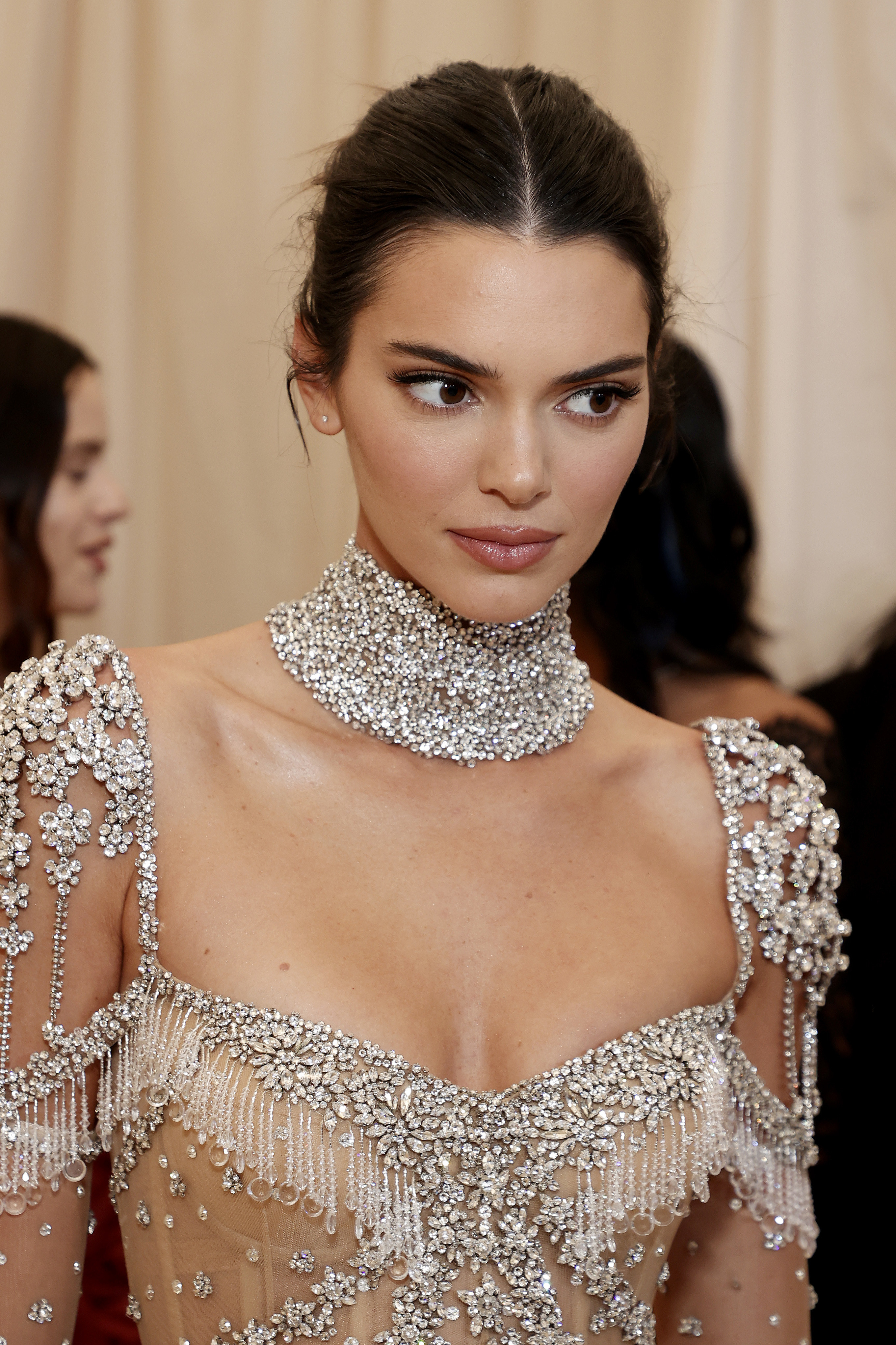 Close-up of Kendall wearing a bejeweled outfit and choker necklace