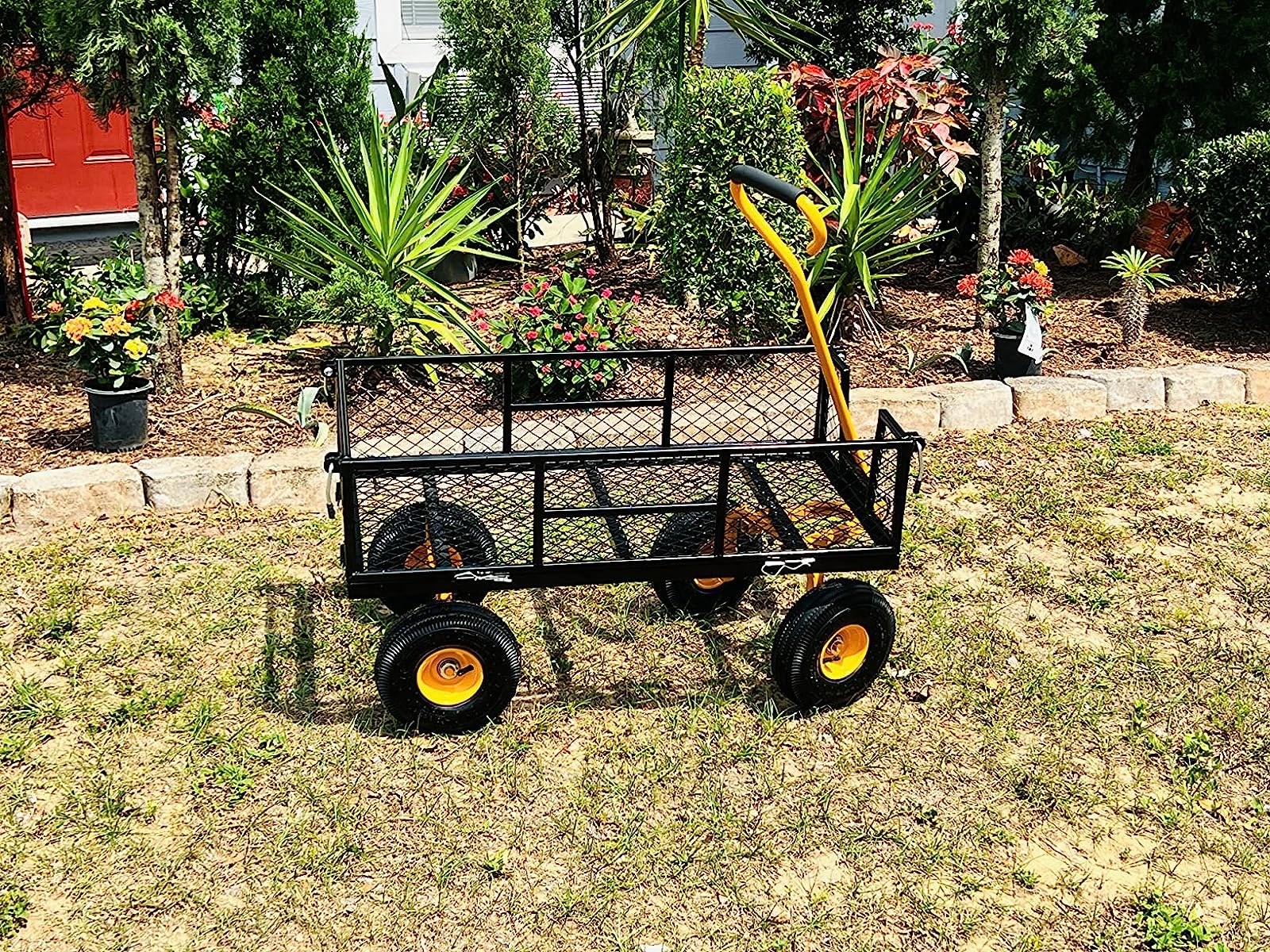 Reviewer&#x27;s black with yellow handle wagon in grass