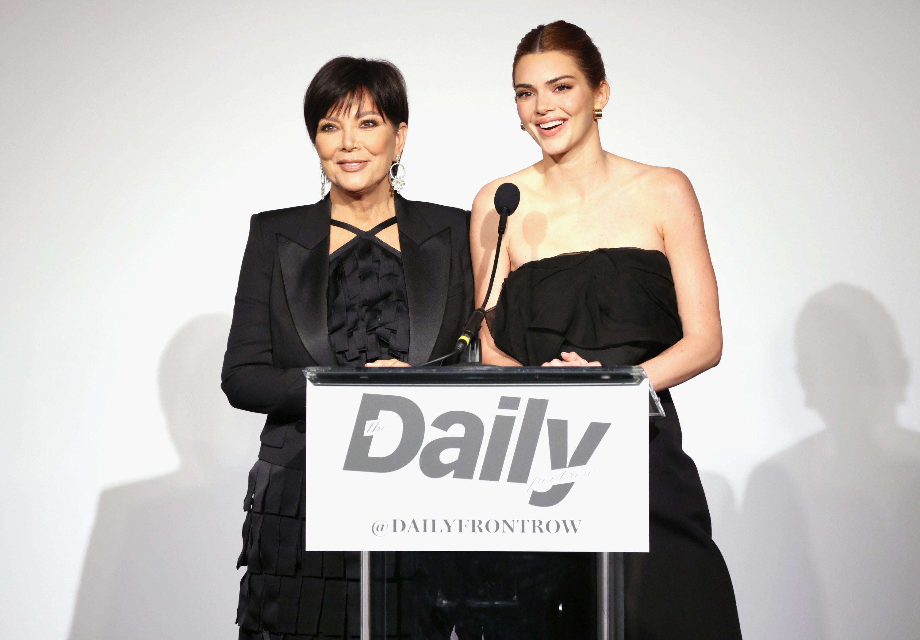Closeup of Kris Jenner and Kendall Jenner at a podium