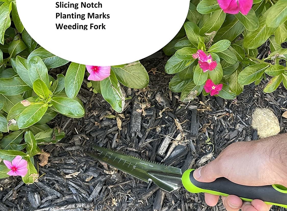 The tool being used in mulch with five uses listed: digging trowel, serrated garden knife, slicing notch, planting marks, and weeding fork