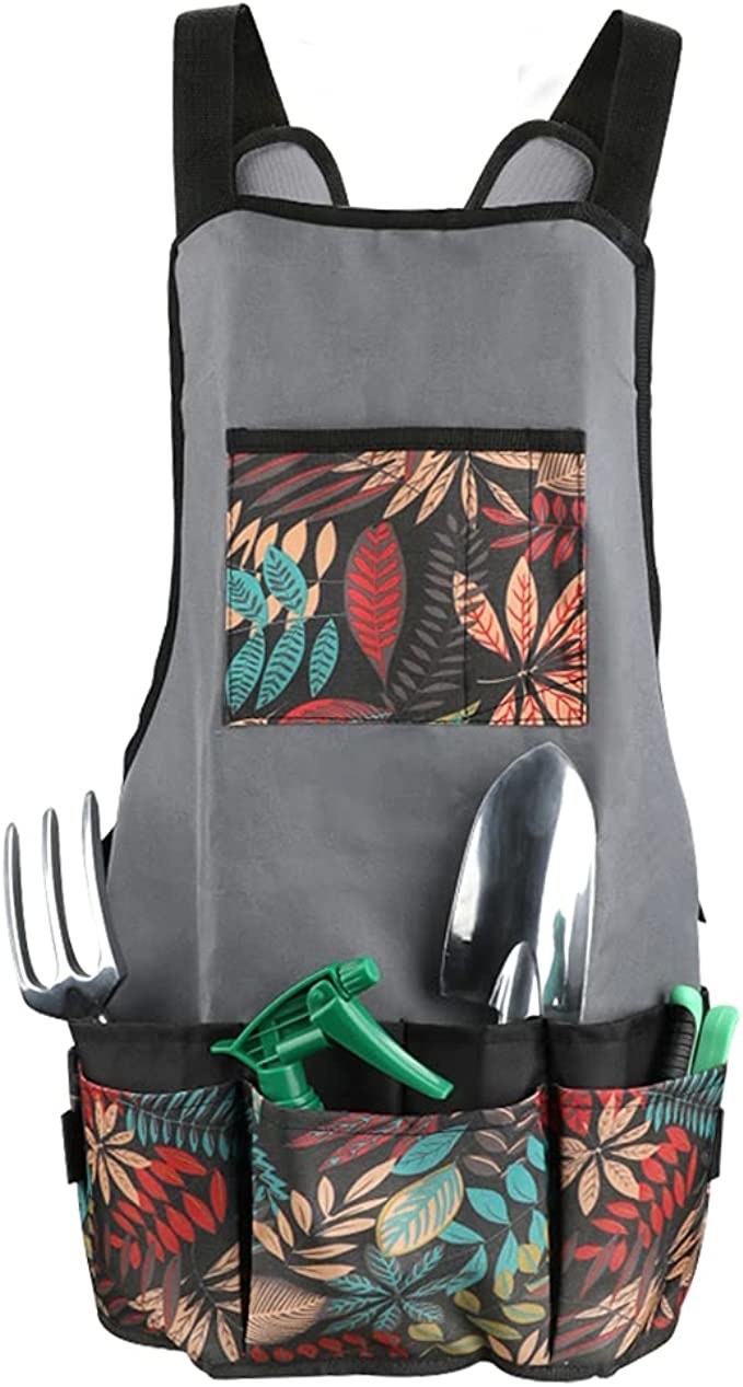 the apron with spade, fork, and spray water bottle in pockets
