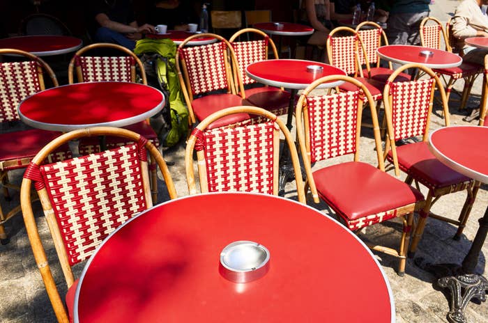 Paris cafe tables in summer sunshine.