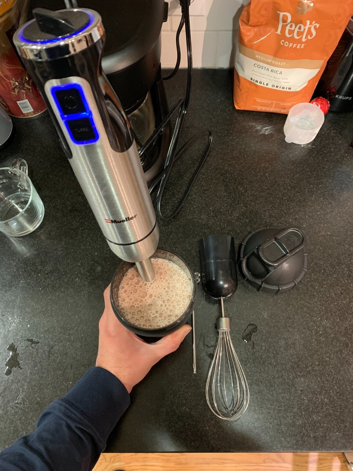Reviewer using immersion blender to mix up protein drink smothie