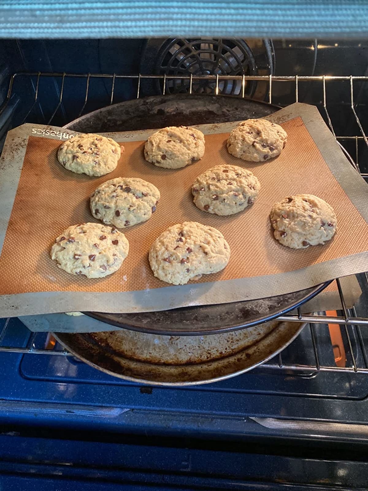 Reviewer baking cookies on reusable silicone sheet