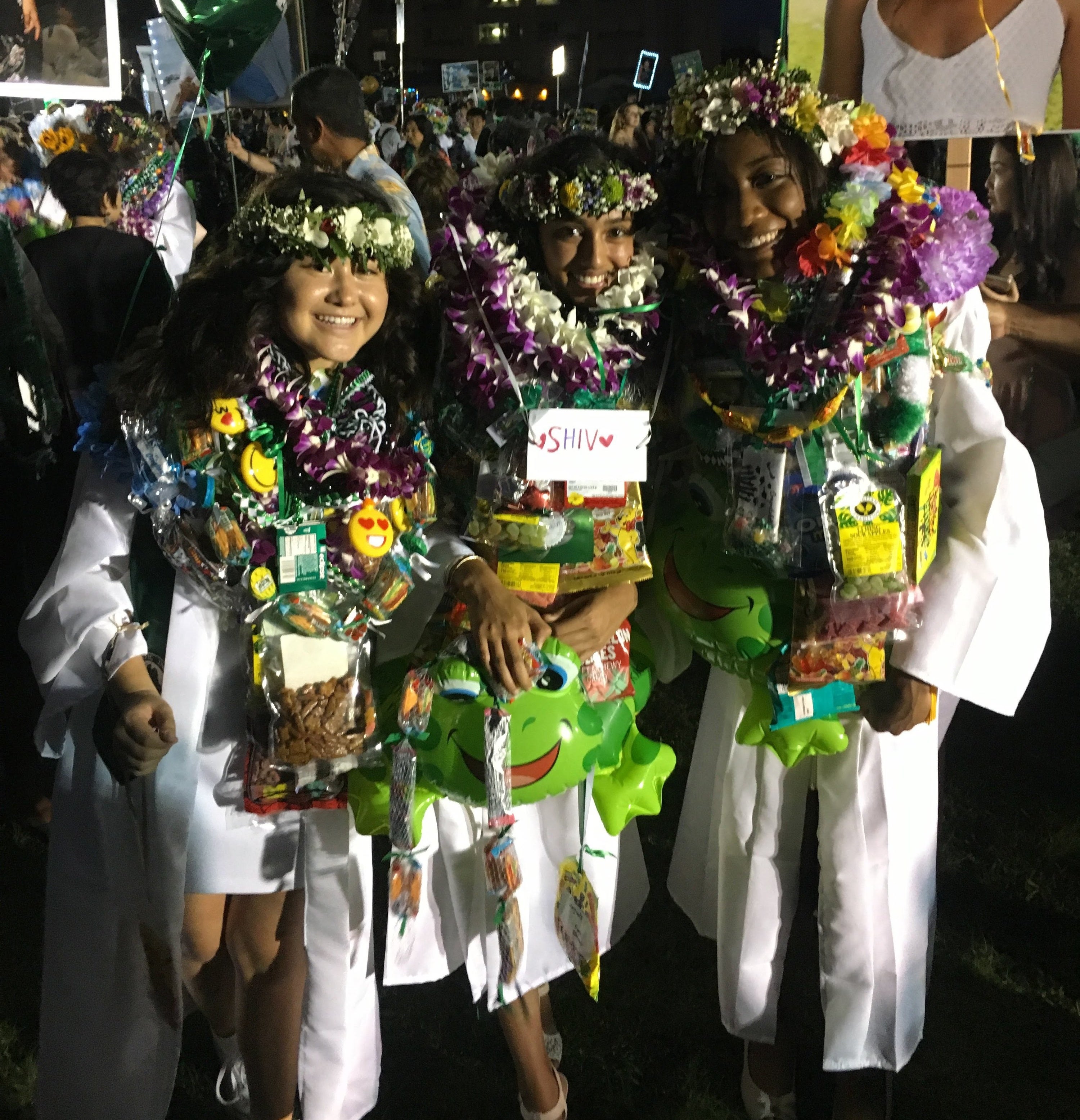 Graduates in leis and flower wreaths