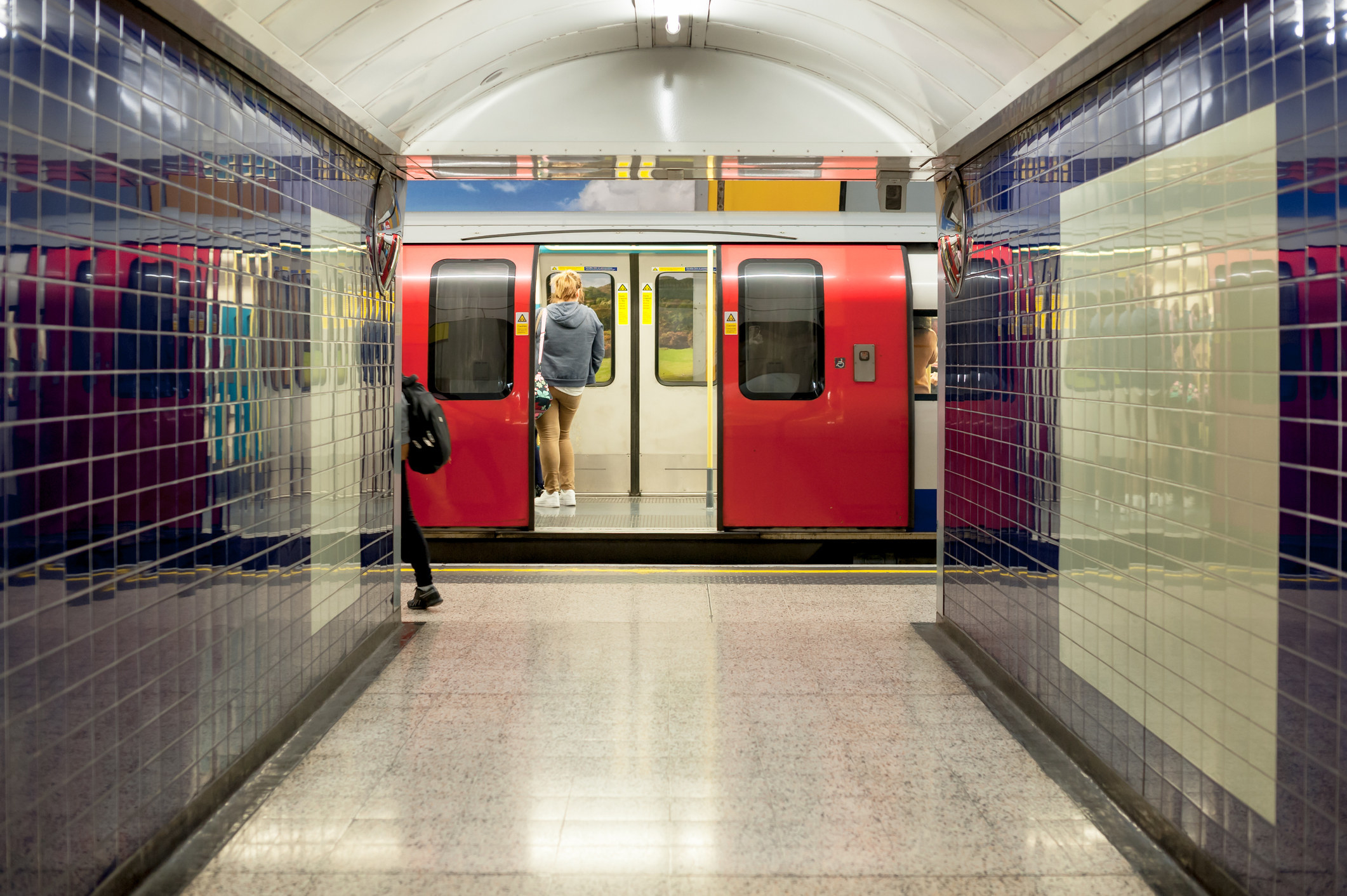 A tube train standing at the station in London.
