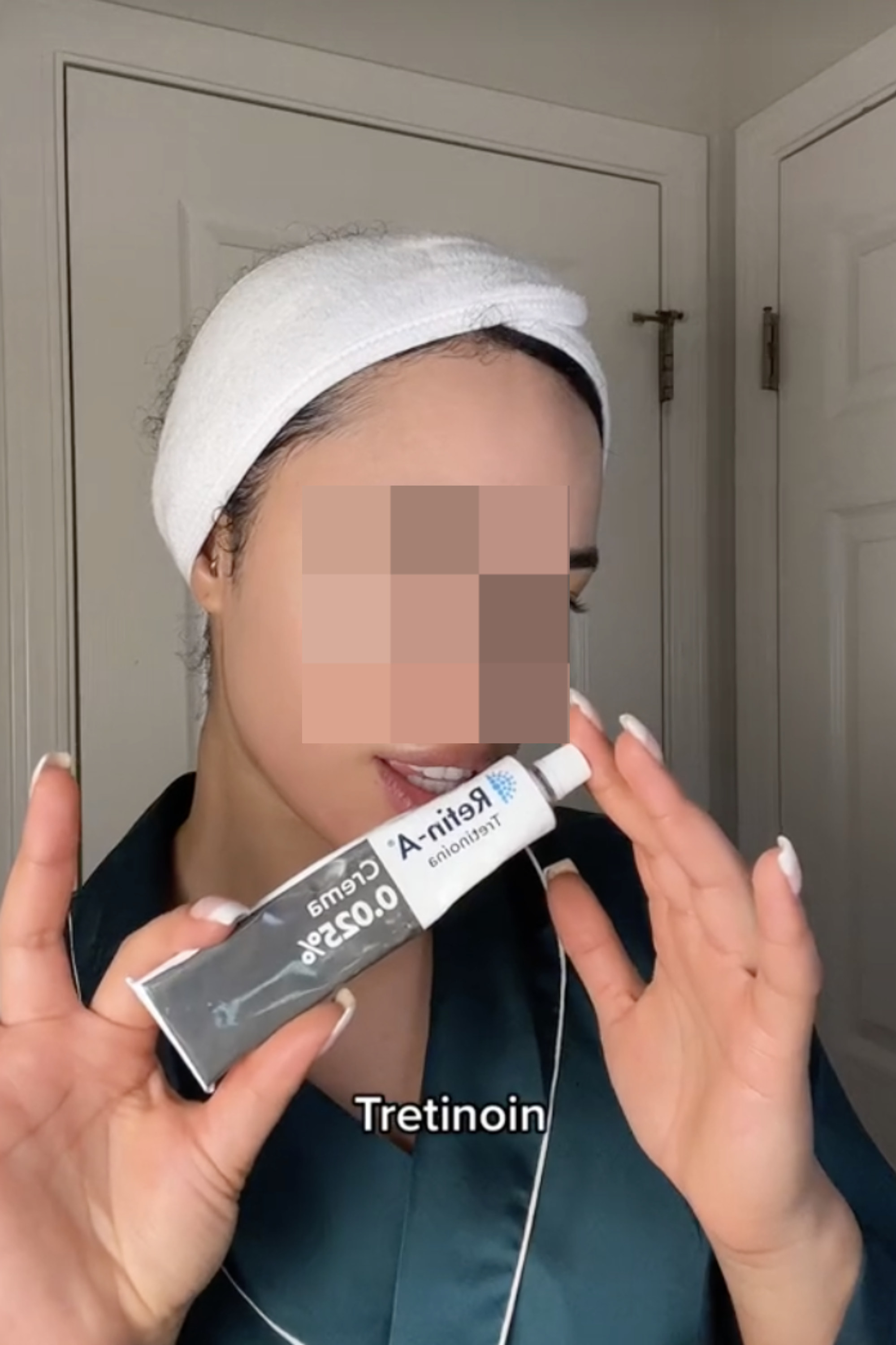 a woman putting tretinoin on her skin