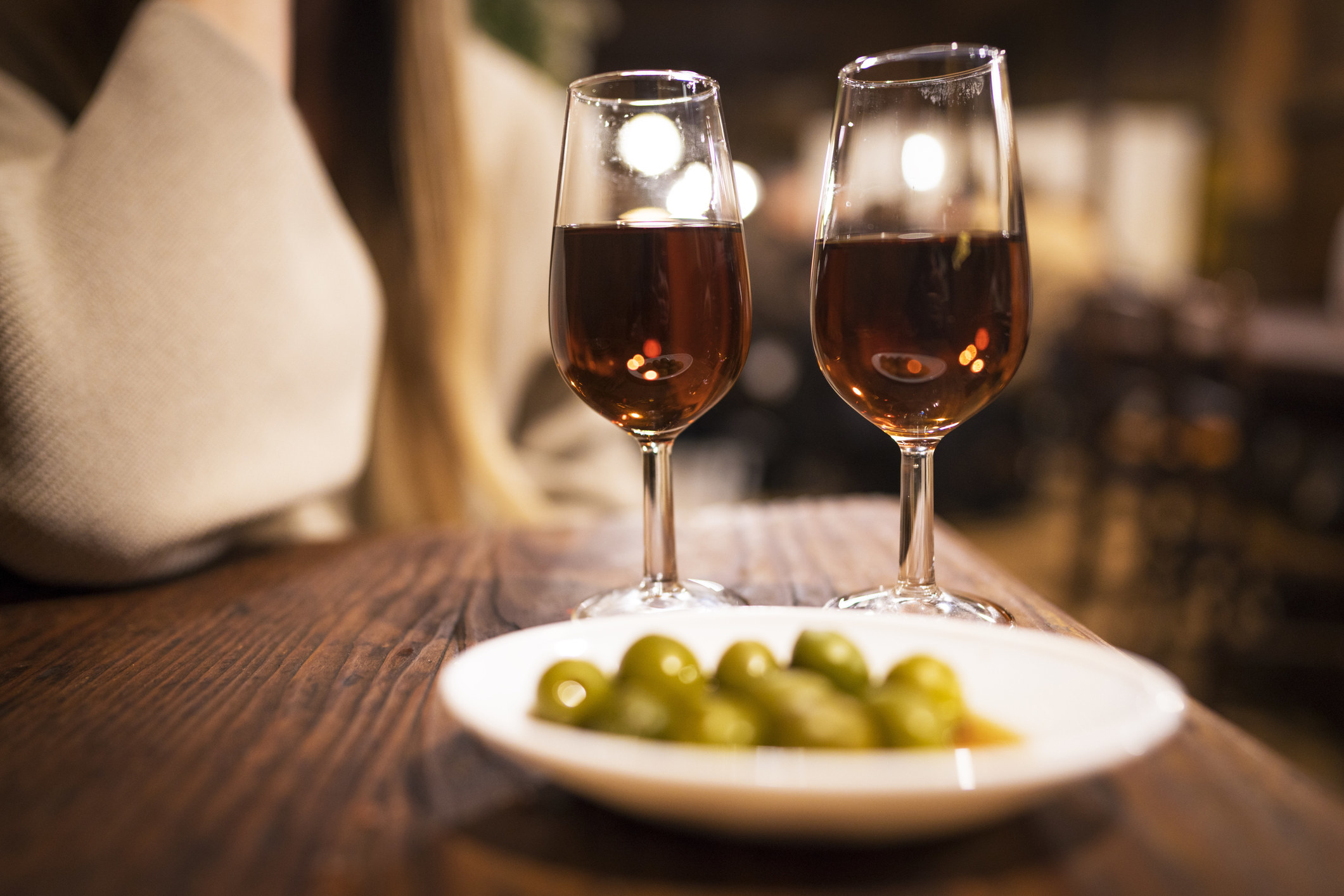 Vermouth and olives at a bar.