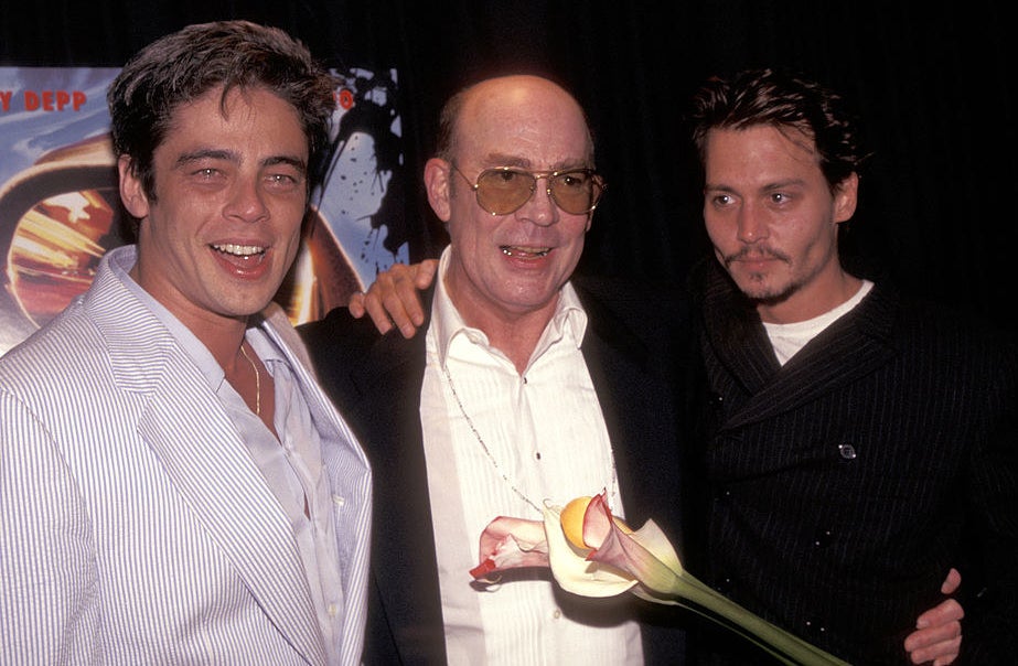 Benicio Del Toro, Hunter S. Thompson and Johnny Depp smiling at a movie premiere