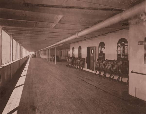 covered deck with folded chairs along the wall