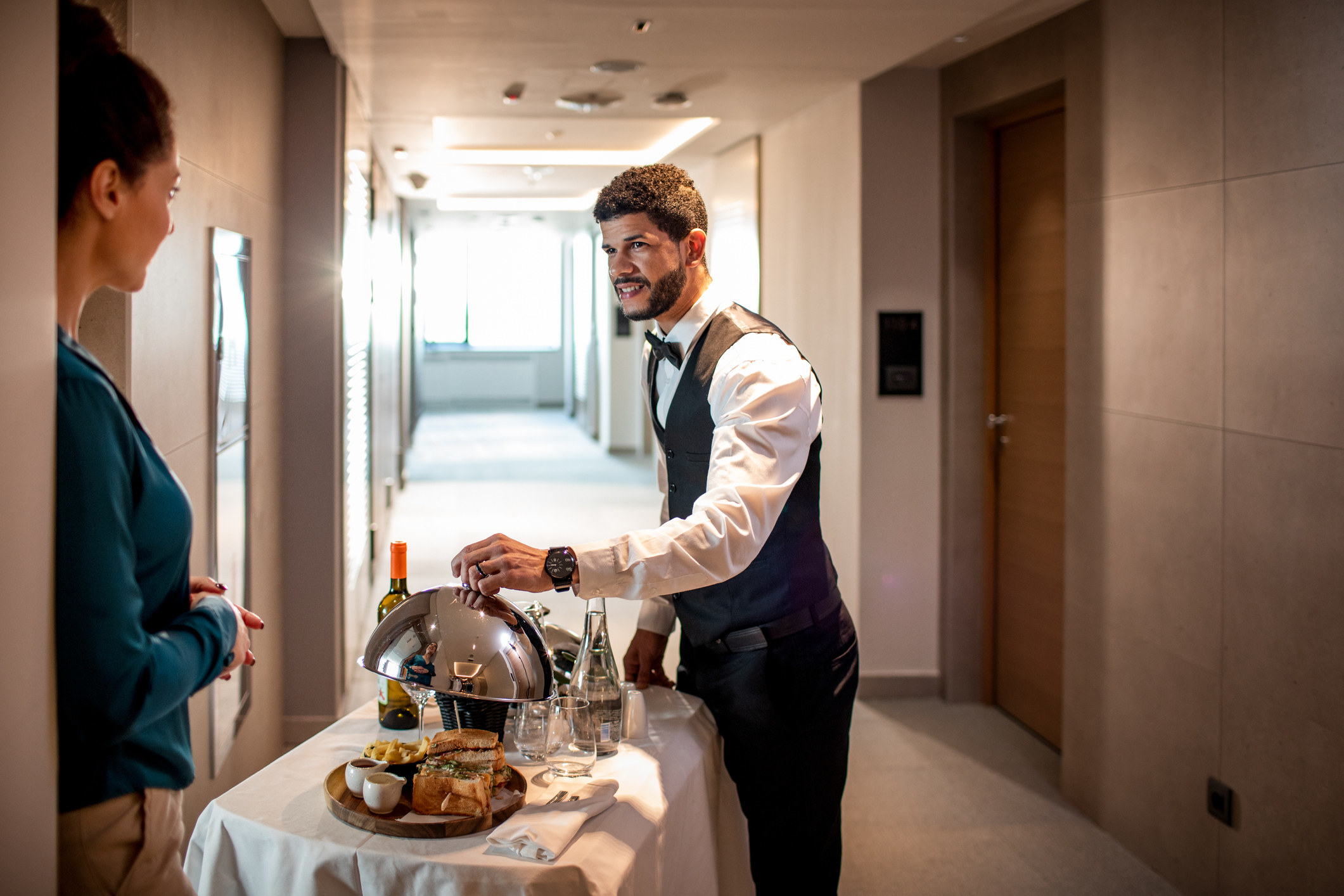 A hotel employee delivering room service