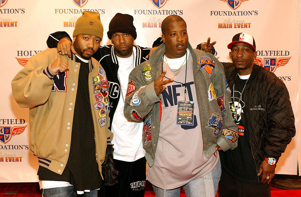 members of outlawz posing for photos on a red carpet