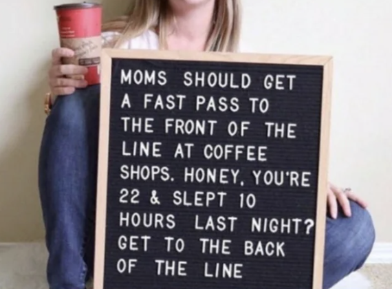 mom with a sign reading moms should get a free pass to the front of the line at coffee shops, honey, you&#x27;re 22