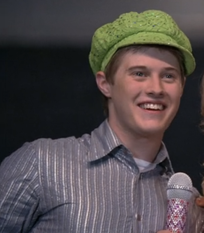 Lucas Grabeel as Ryan wearing a cap