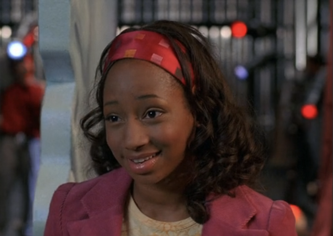 Monique Coleman as Taylor wearing a headband