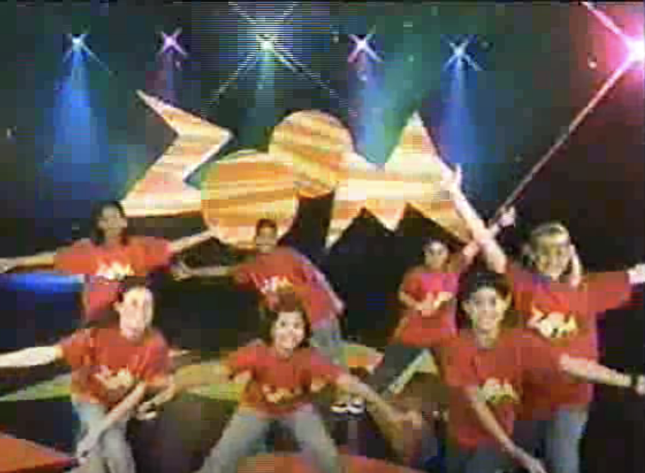kids dancing in front of a large zoom sign