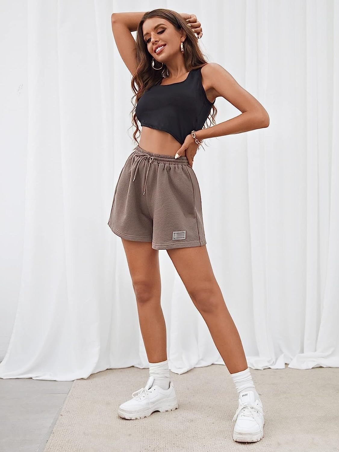 model wearing light brown sweat shorts