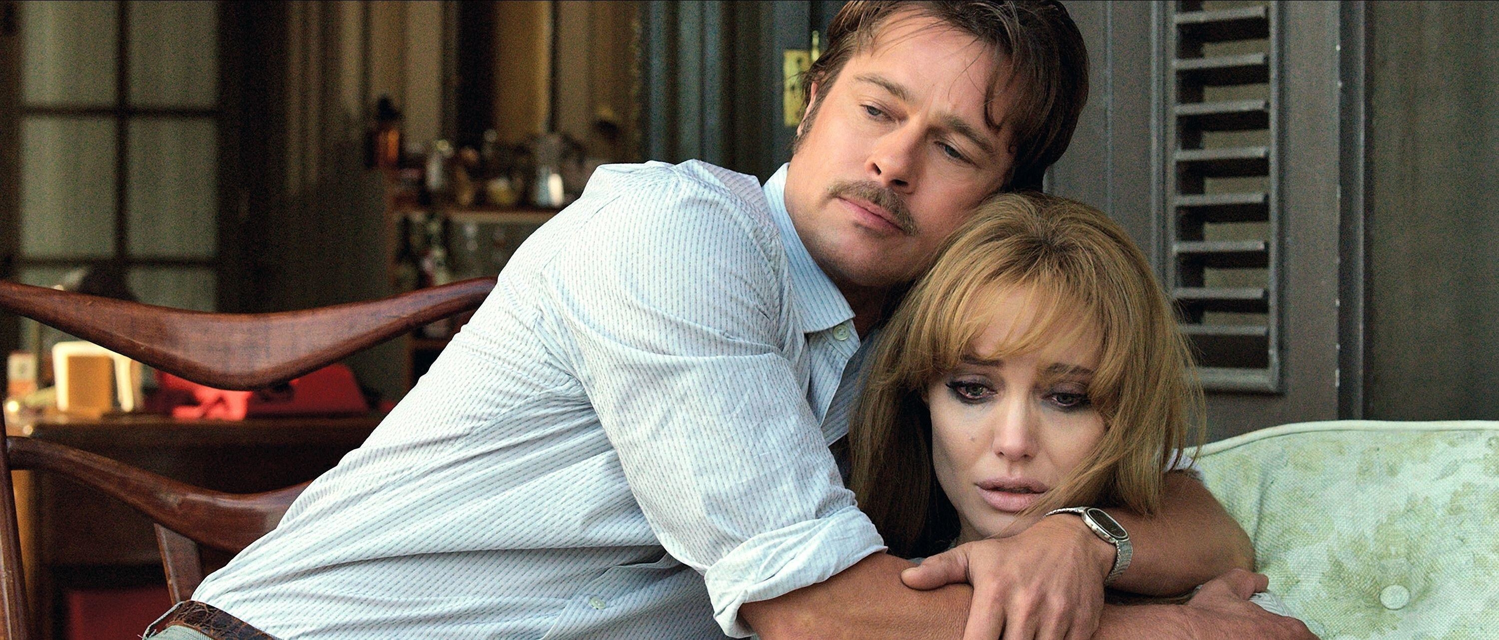 Brad Pitt wraps his arms around a distressed Angelina Jolie