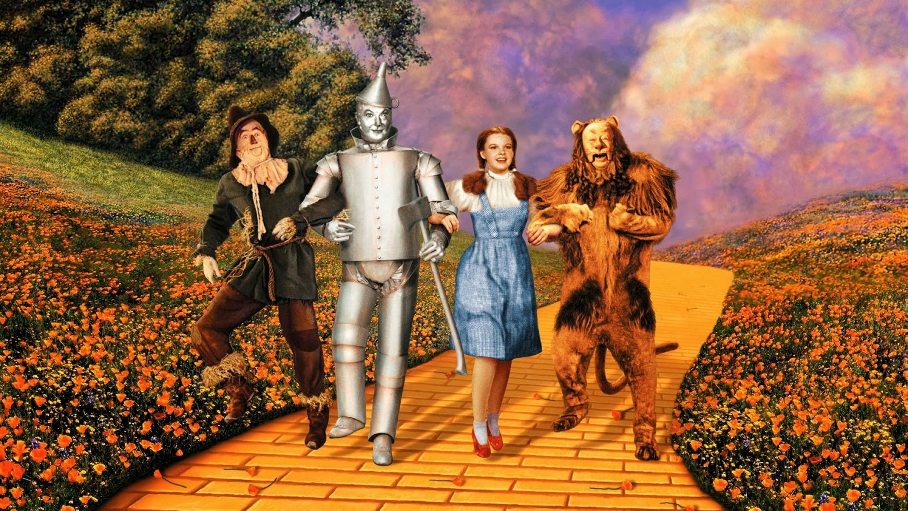 The Scarecrow, Tin Man, Dorothy Gale and the Cowardly Lion walk down the yellow brick road