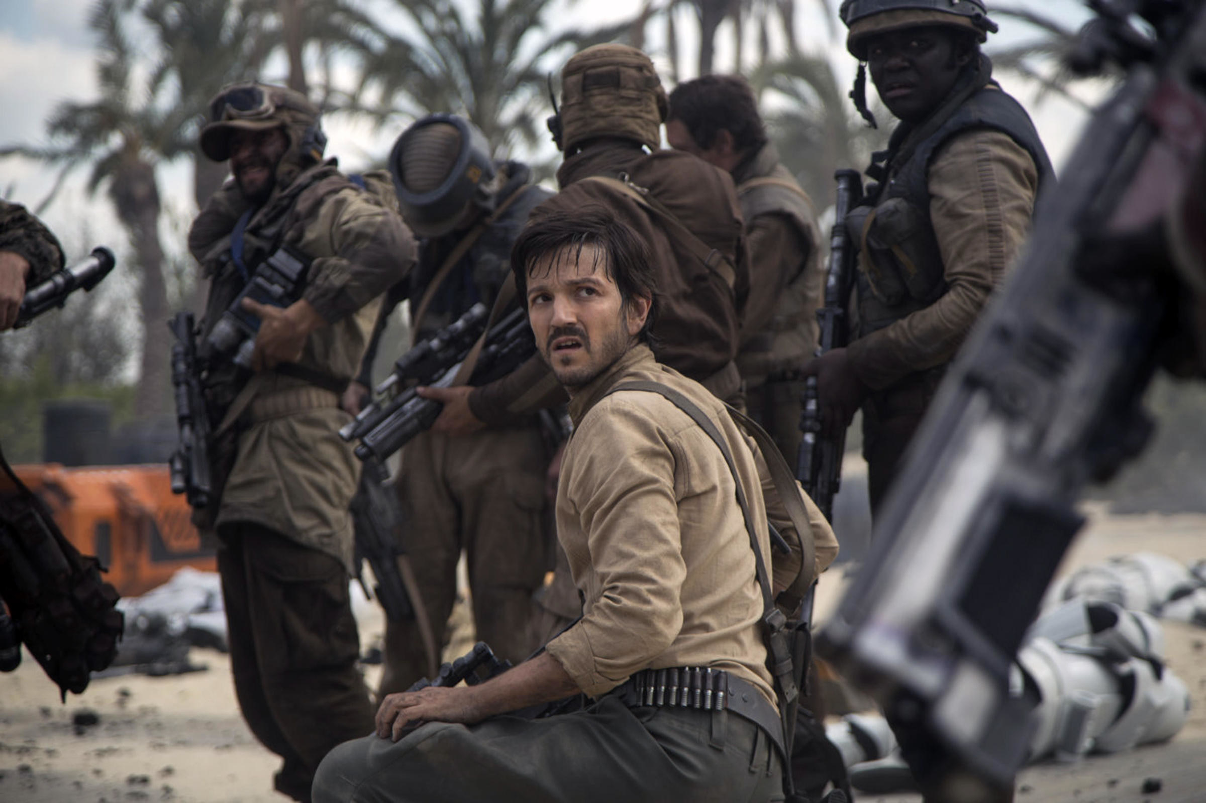 Diego Luna kneels on a beach near resistance fighters in &quot;Rogue One&quot;