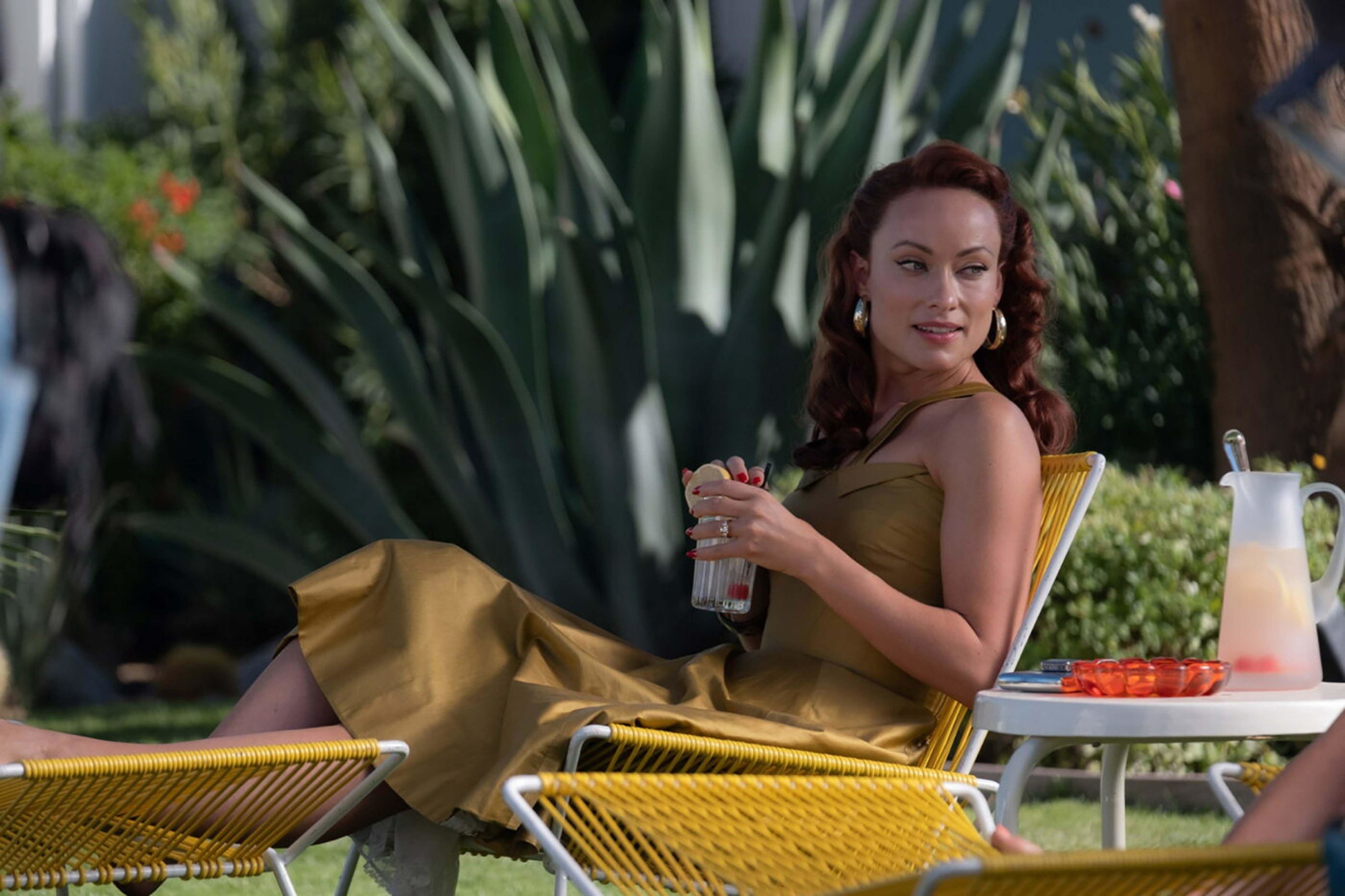 Olivia Wilde enjoys a cold drink on a lounge chair