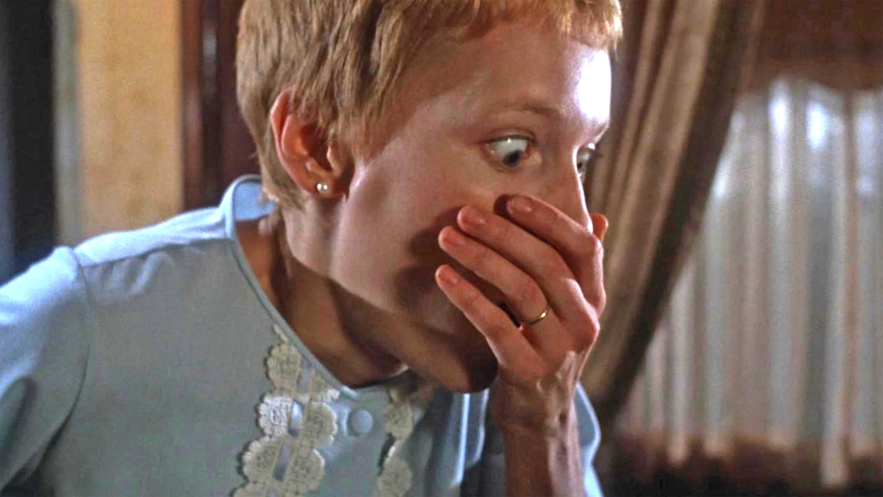 Mia Farrow covers her agape mouth in “Rosemary’s Baby”