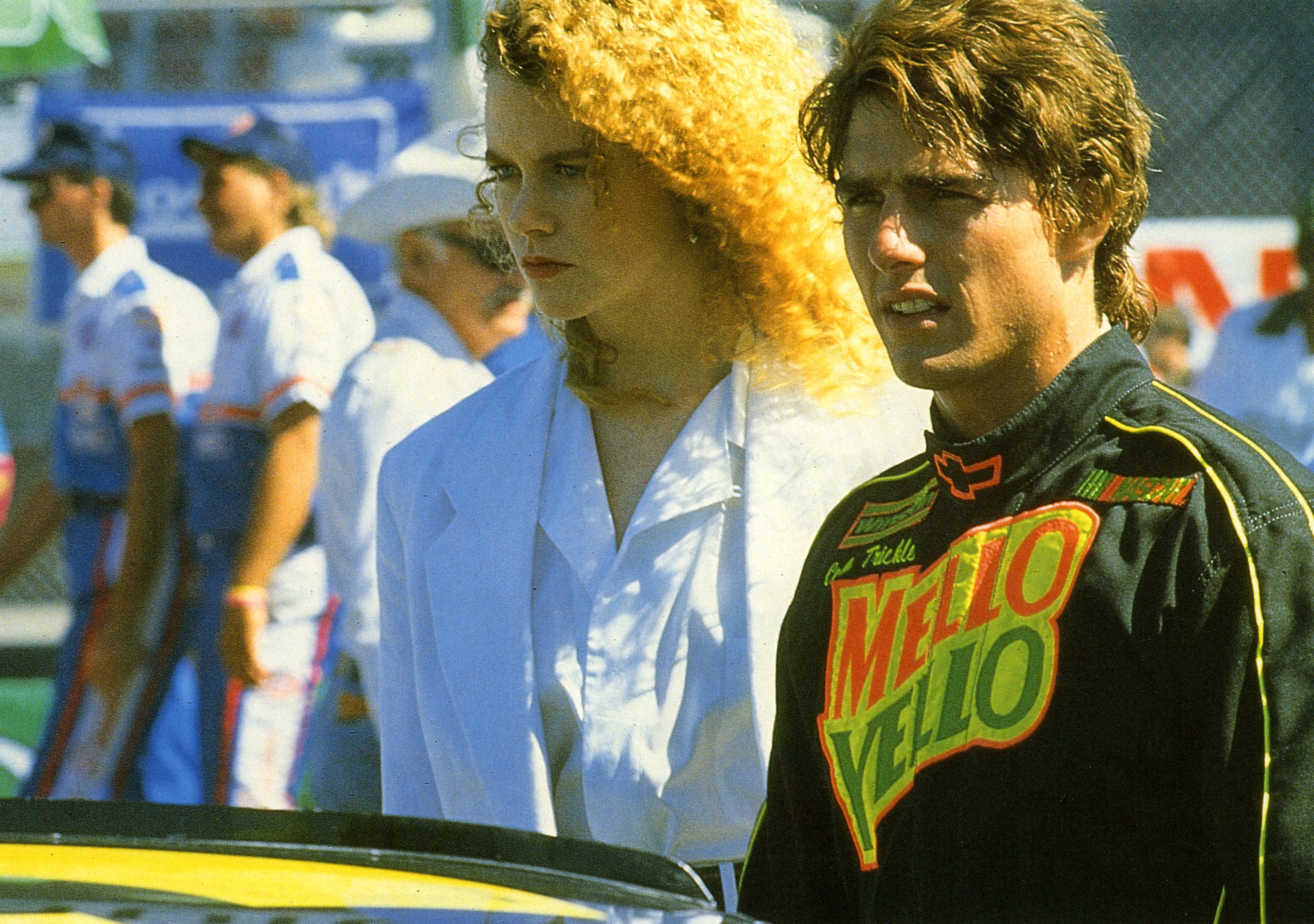 Tom Cruise and Nicole Kidman stand near a race car