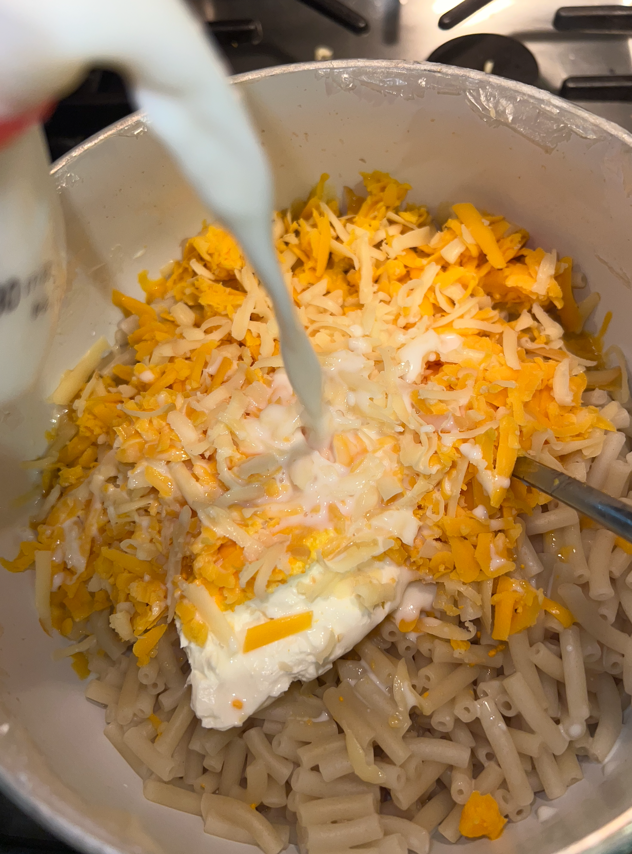 Milk being added to macaroni mixture