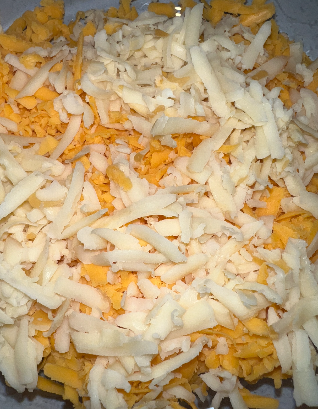 Close-up of grated cheeses