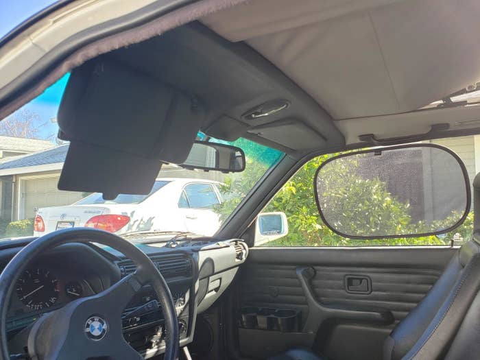 Reviewer&#x27;s image of car interior with window shade attached to window