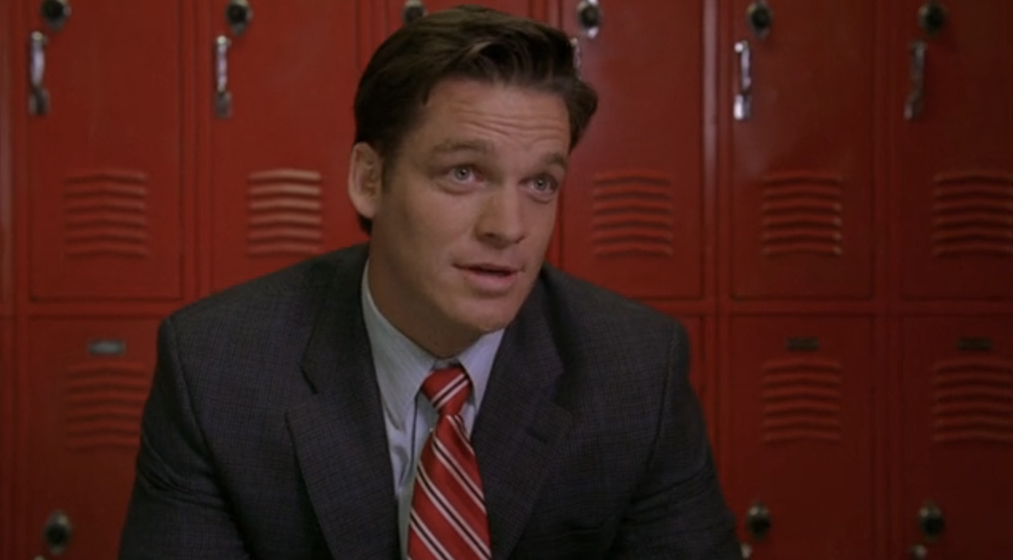 Bart Johnson as Coach Bolton in front of school lockers