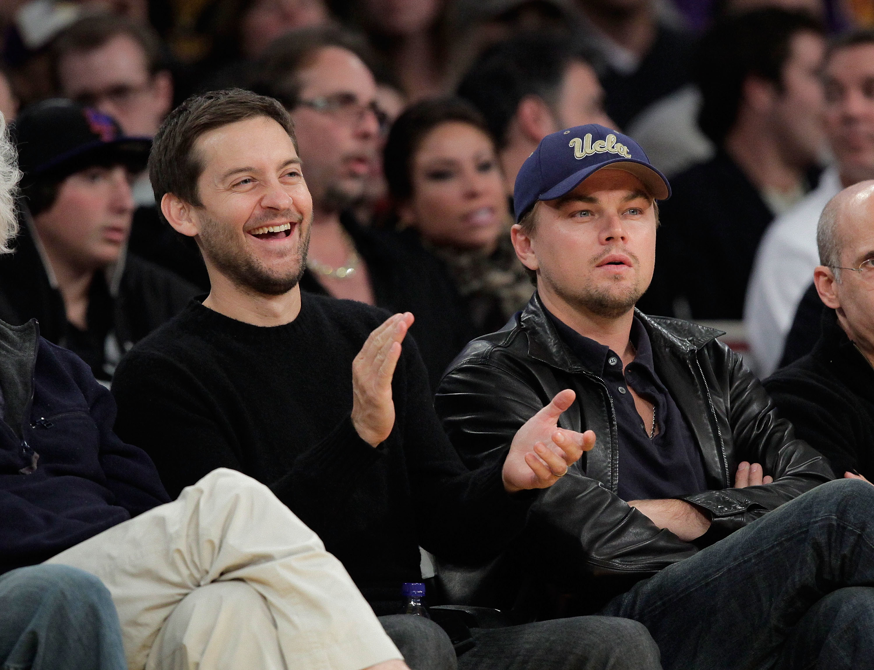 Close-up of Leo and Tobey sitting in an audience