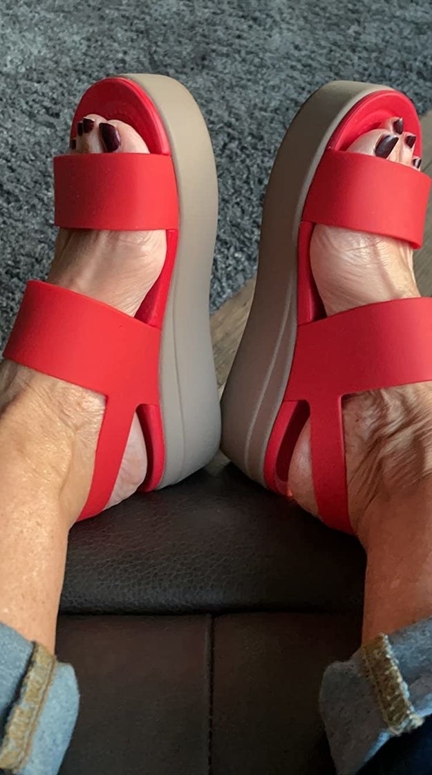 A reviewer wearing red sandals