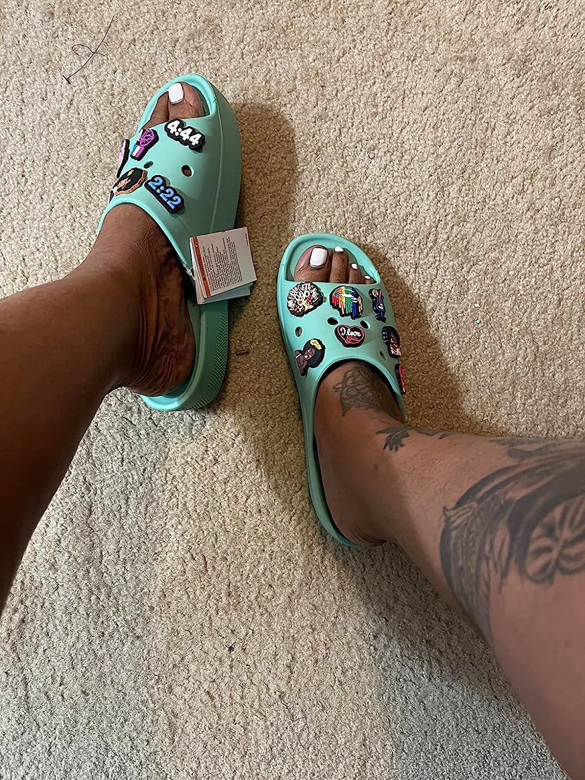 A reviewer wearing teal sandals
