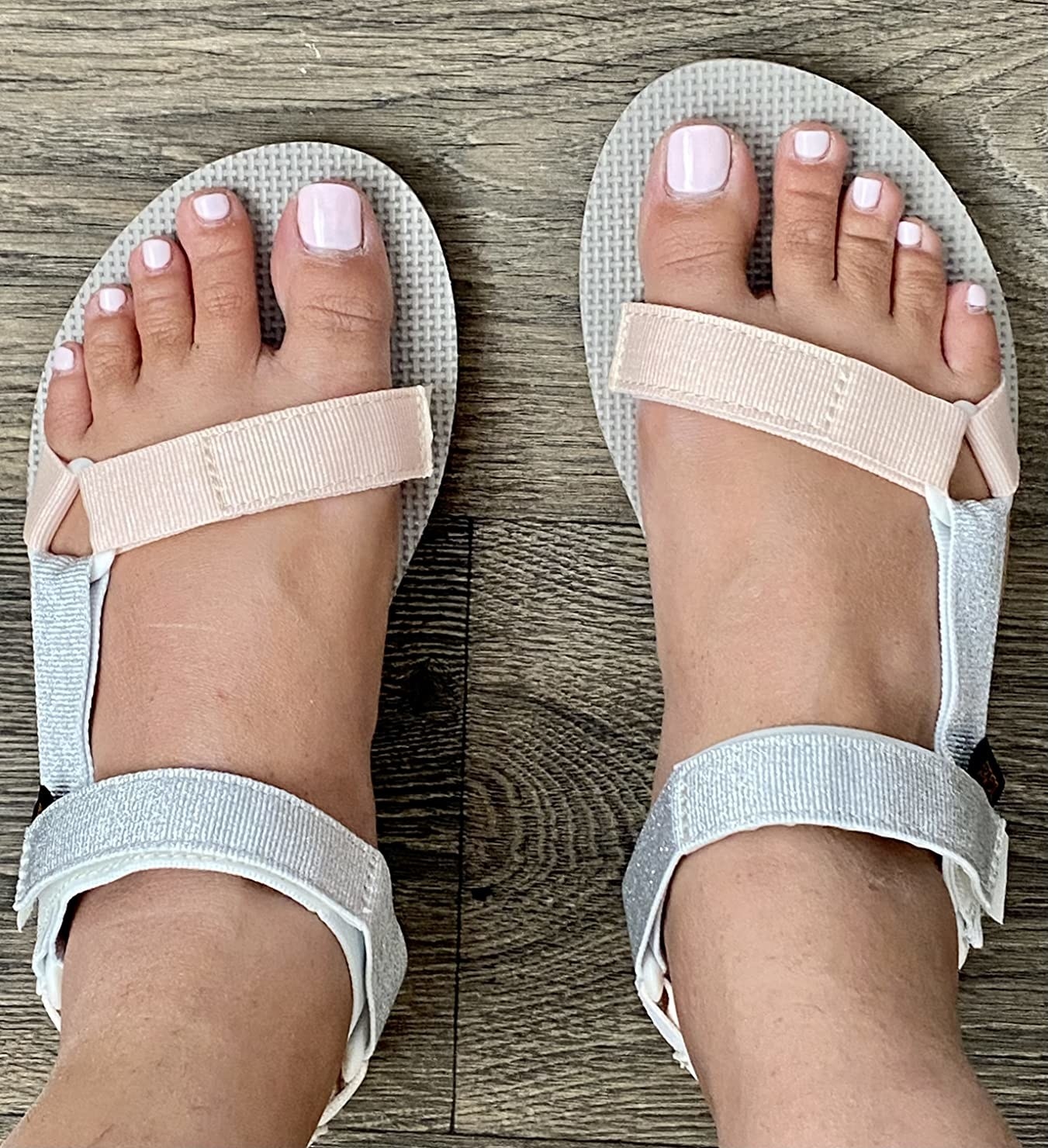 A reviewer wearing white sandals