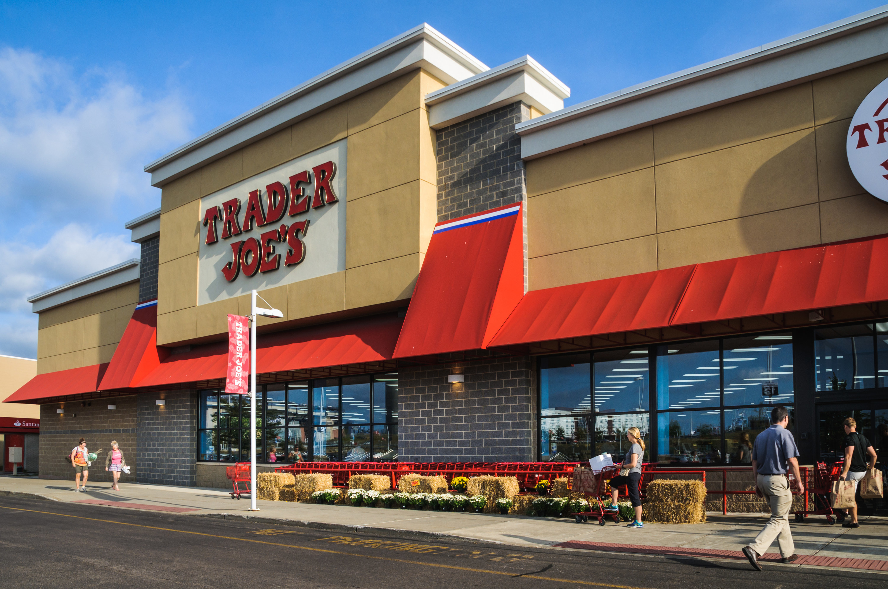 Exterior view of a Trader Joe's store with customers walking in