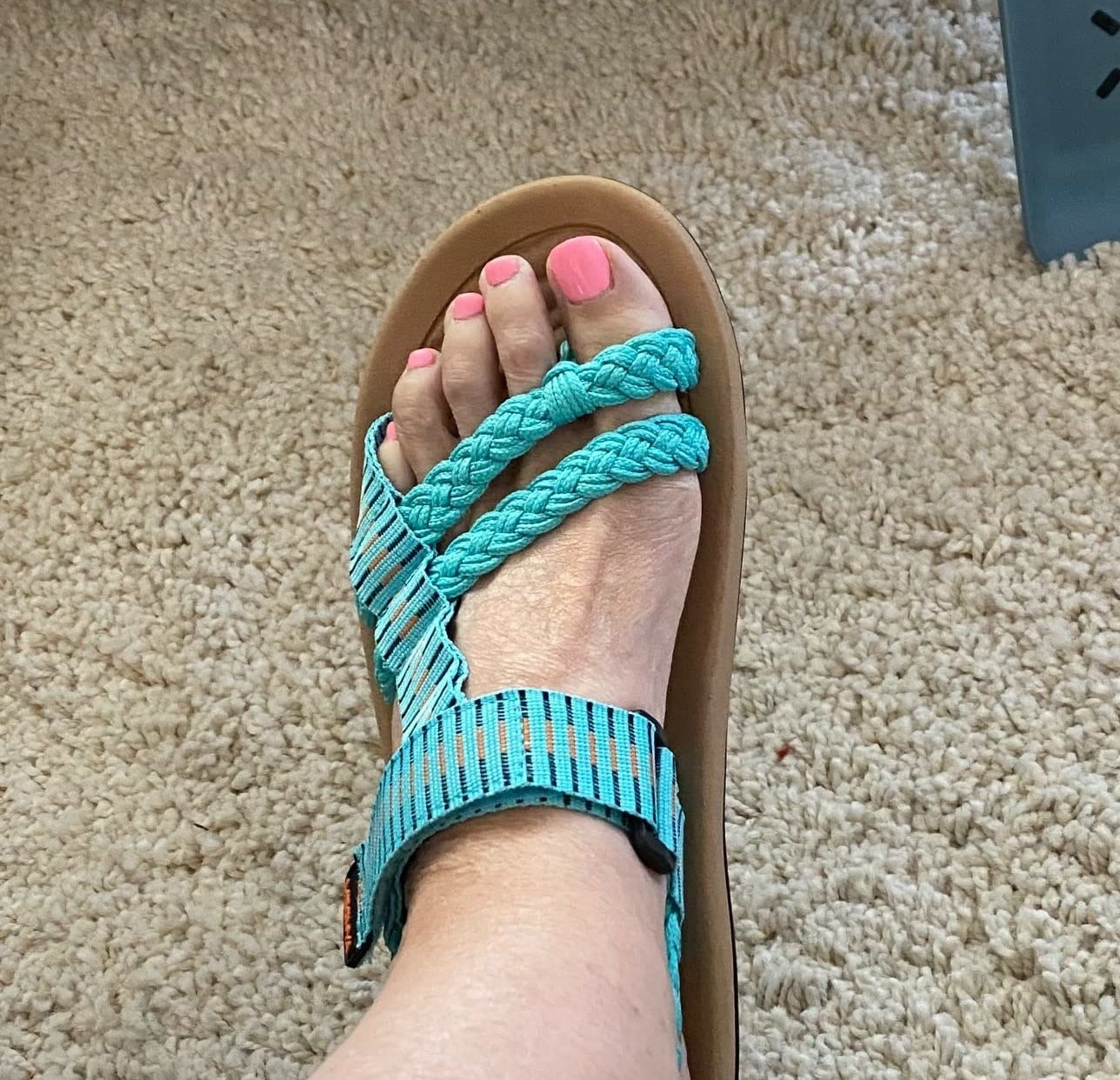 A reviewer wearing blue sandals