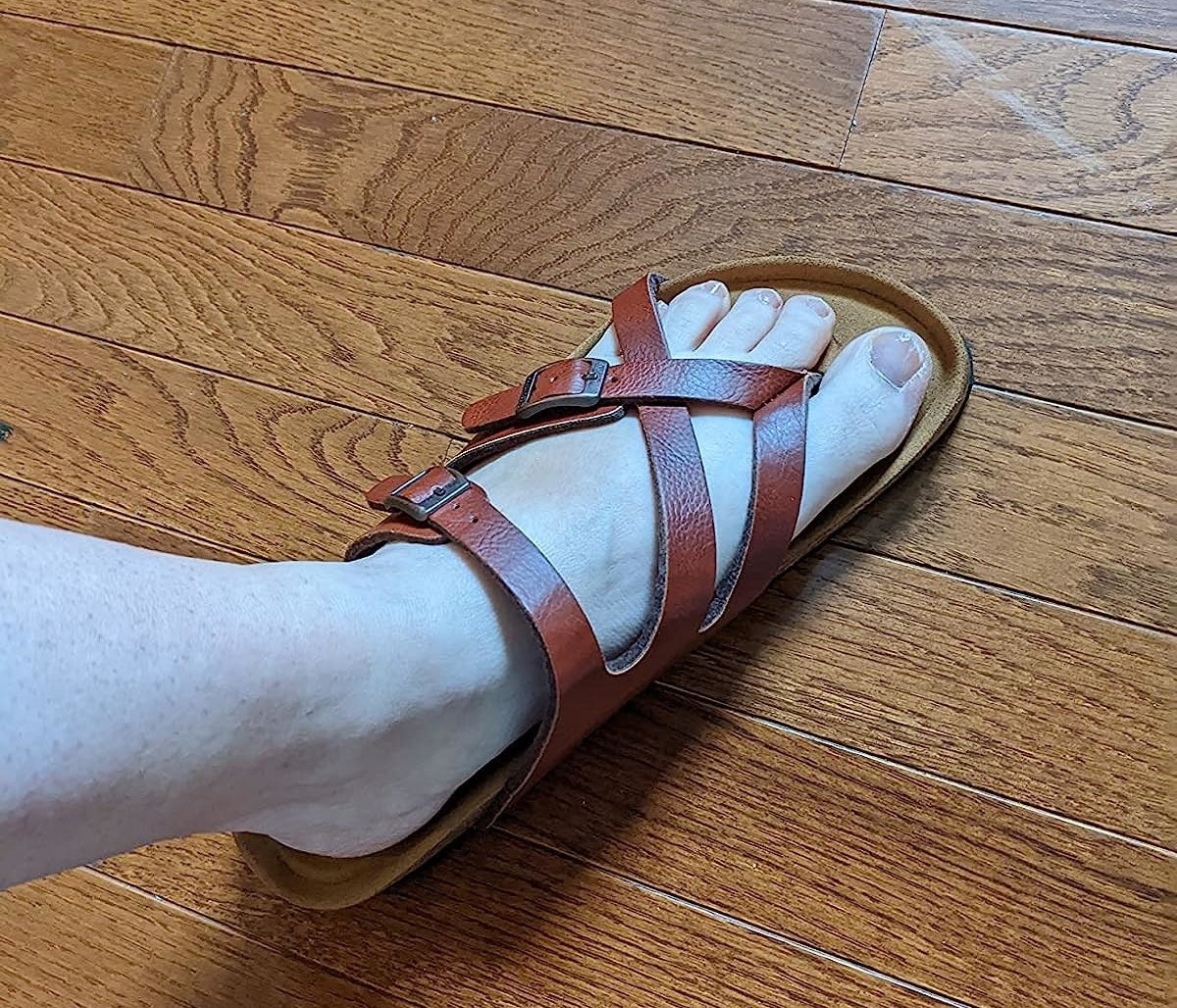 A reviewer wearing brown sandals