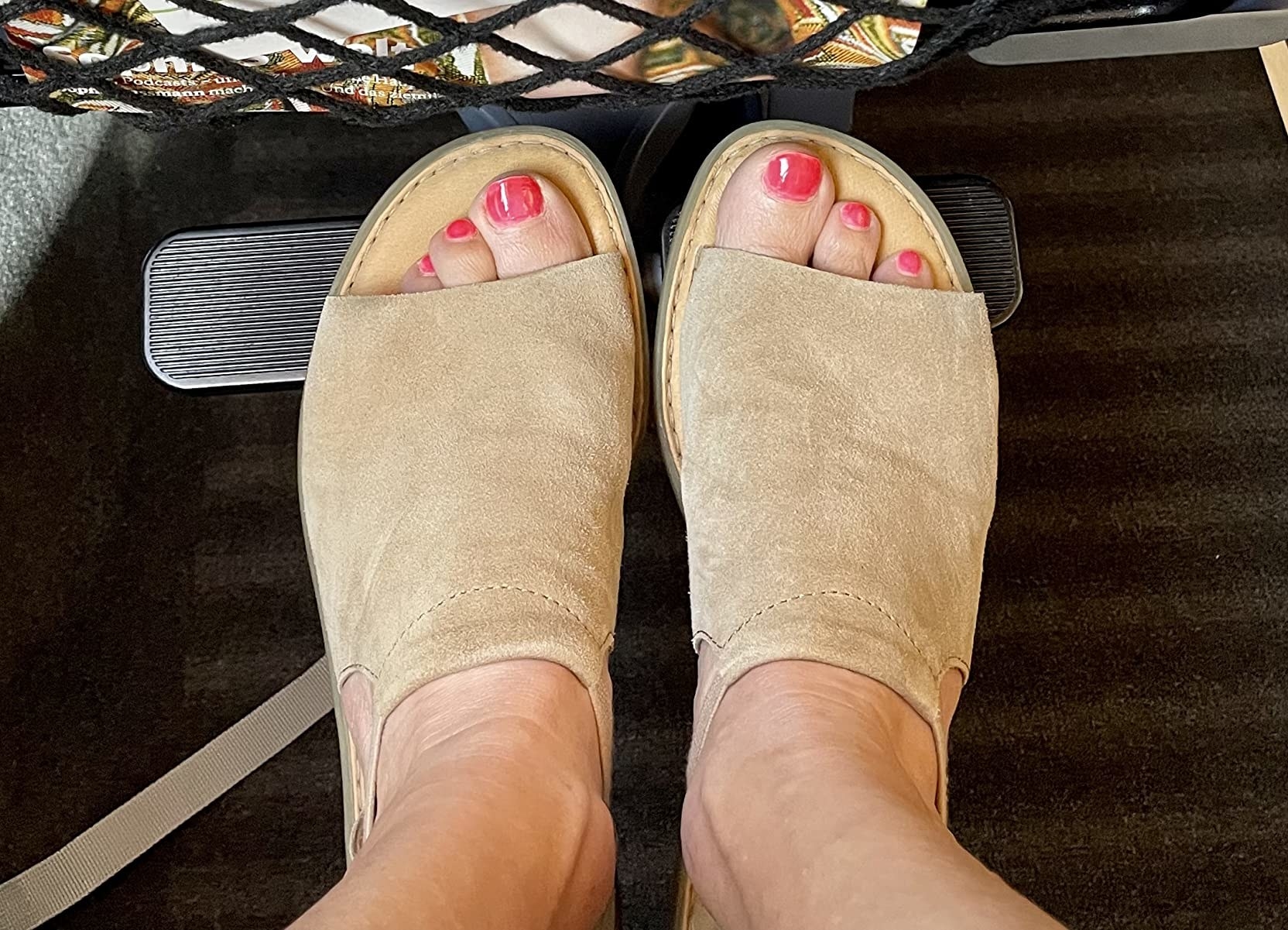 A reviewer wearing beige sandals