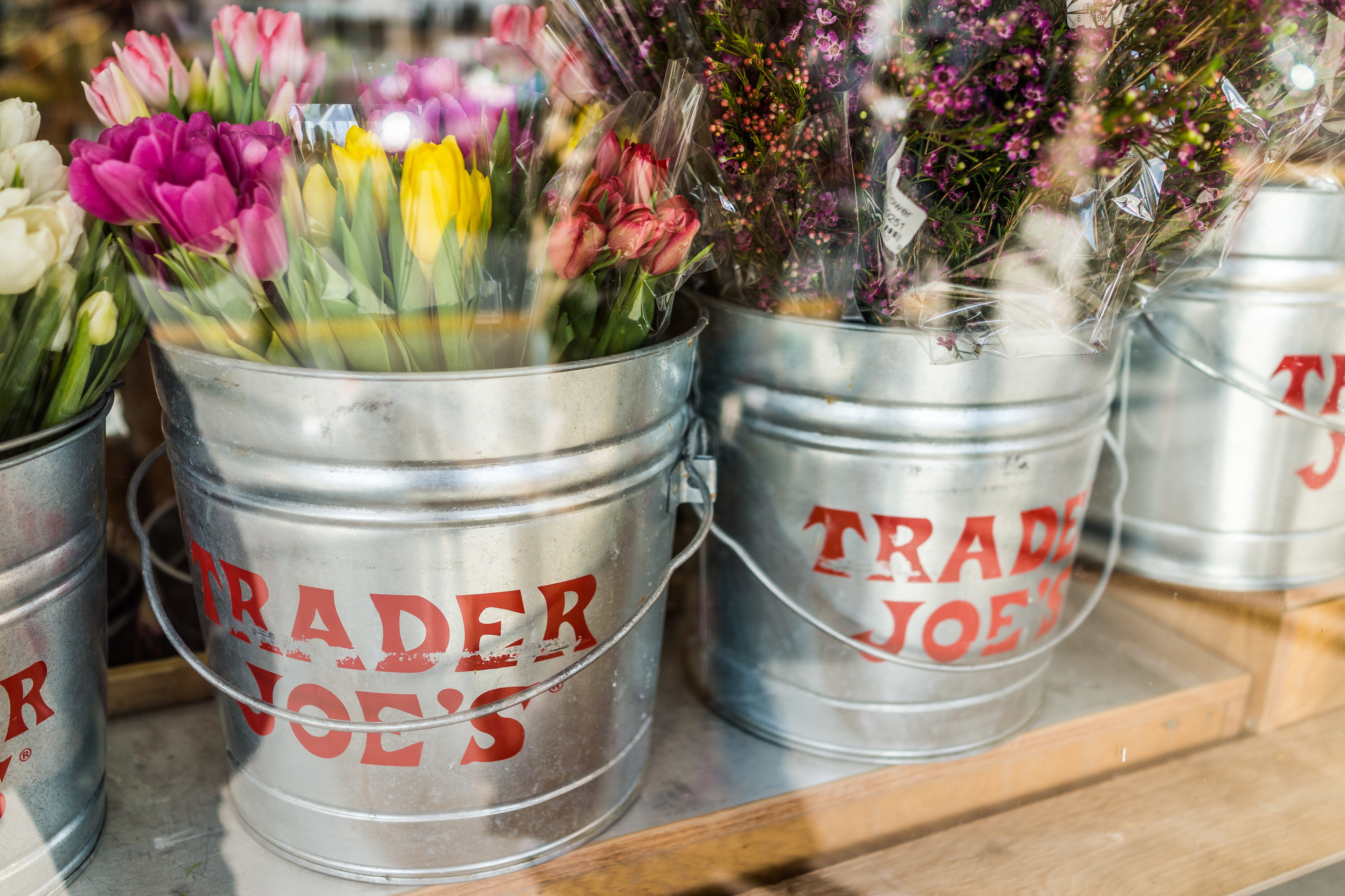 Trader Joe&#x27;s fresh cut flowers in buckets branded with the store&#x27;s brand logo
