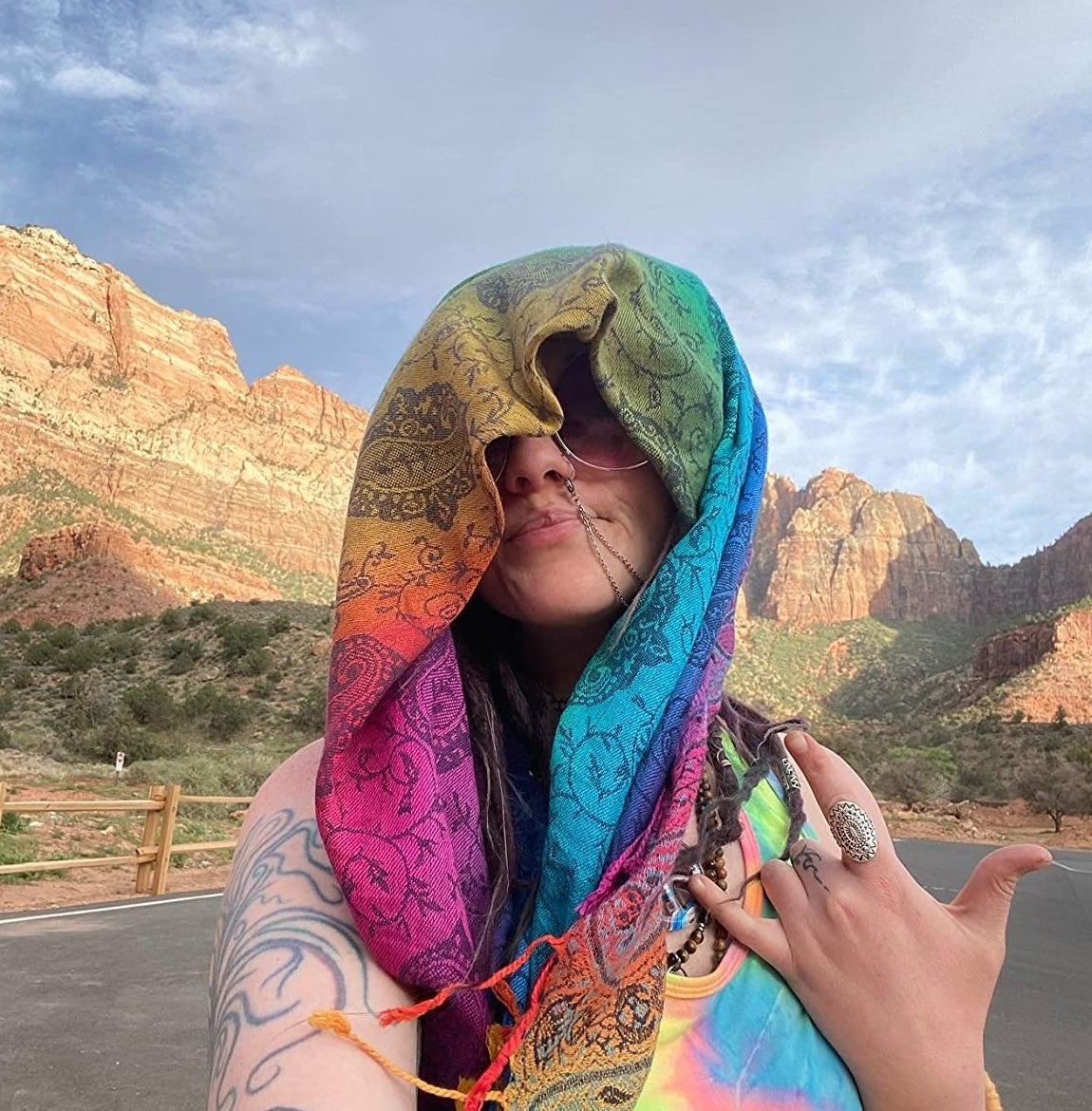 reviewer with a rainbow swirled pashmina wrapped around their head