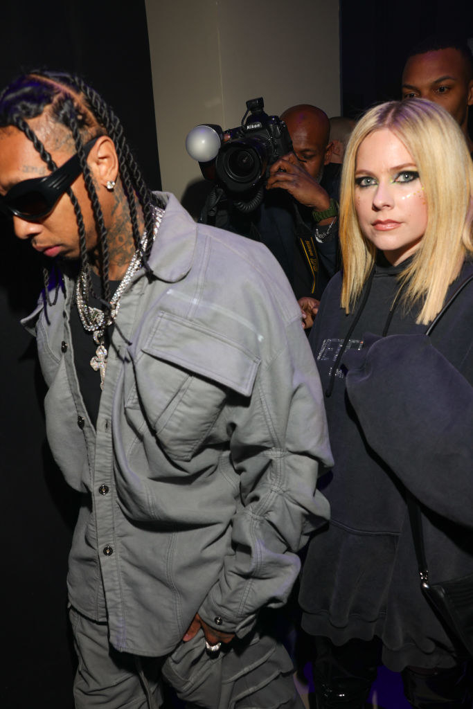 Avril and Tyga with paparazzi behind them