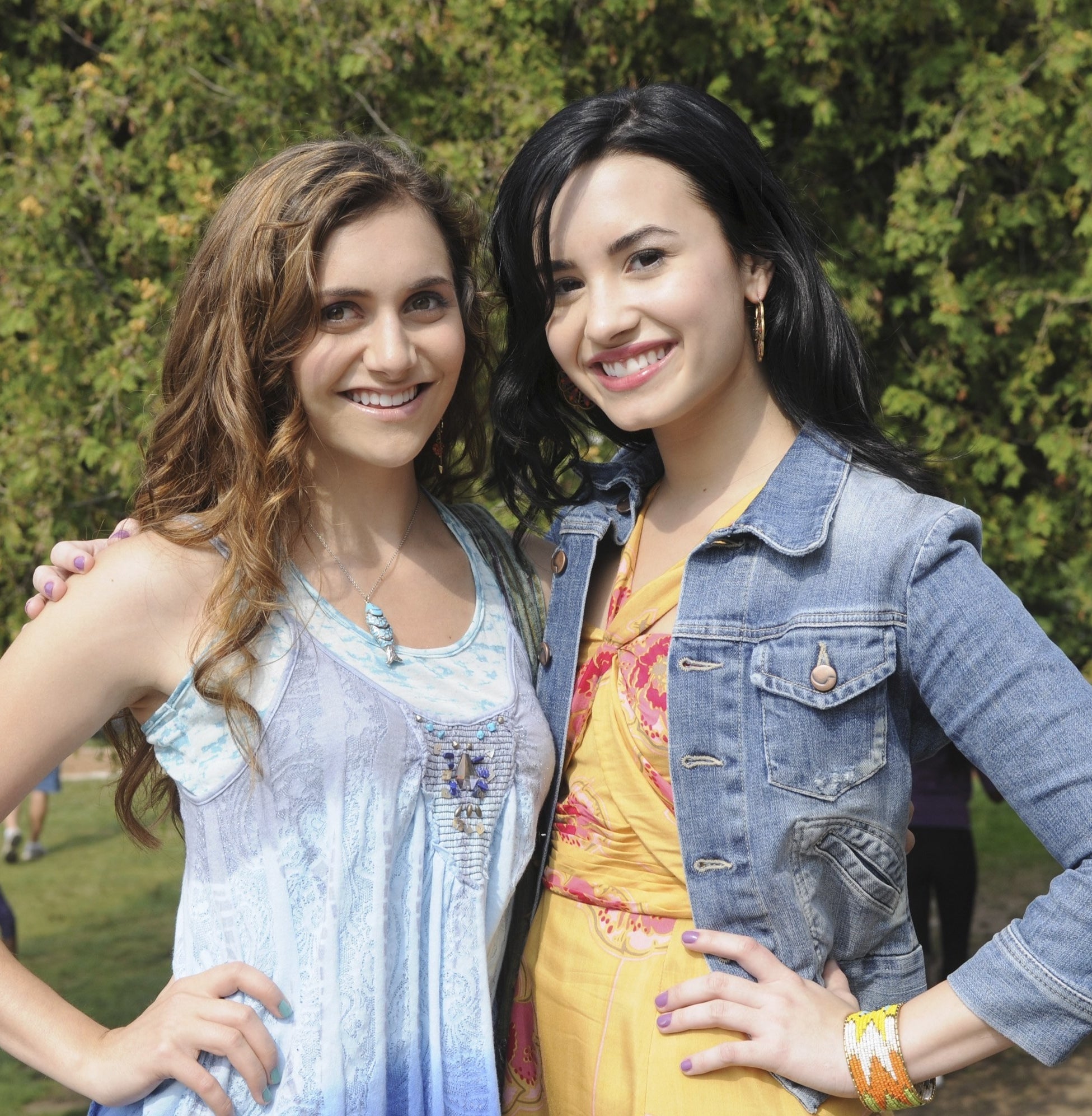 Alyson and Demi as children standing and smiling together