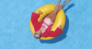 Taylor Swift floating in a pool during the You Need To Calm Down music video