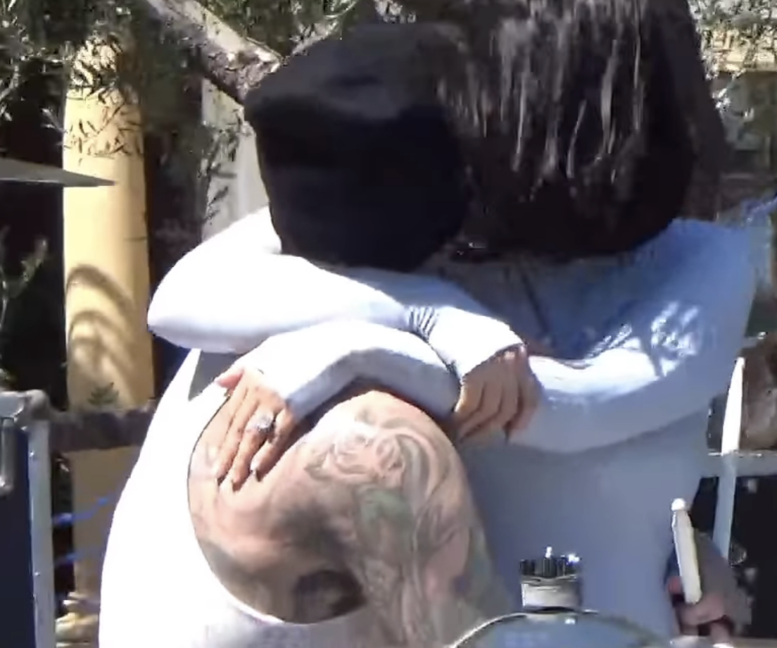 Closeup of Travis Barker and Kourtney Kardashian kissing