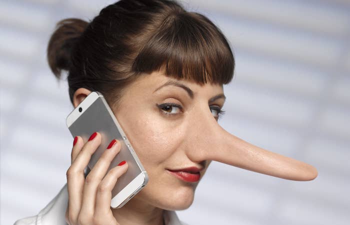 A woman on a phone with her nose growing like Pinocchio