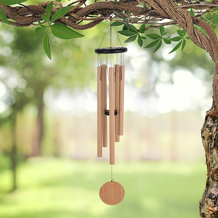 the wind chimes hanging in a backyard