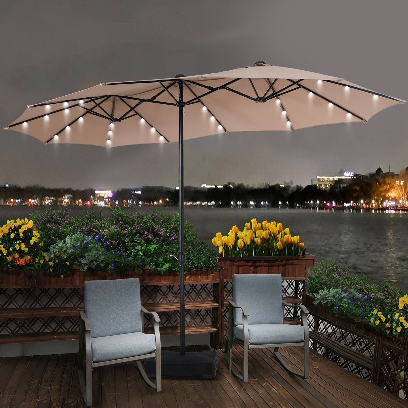 the extra wide umbrella with lights inside on a deck shielding two chairs