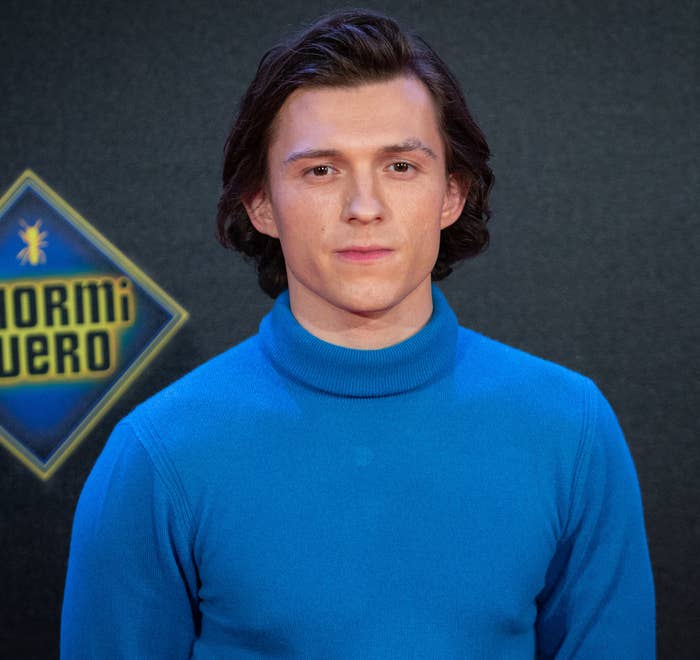 Close-up of Tom looking serious and wearing a turtleneck